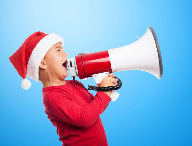 Furious boy holding a bullhorn