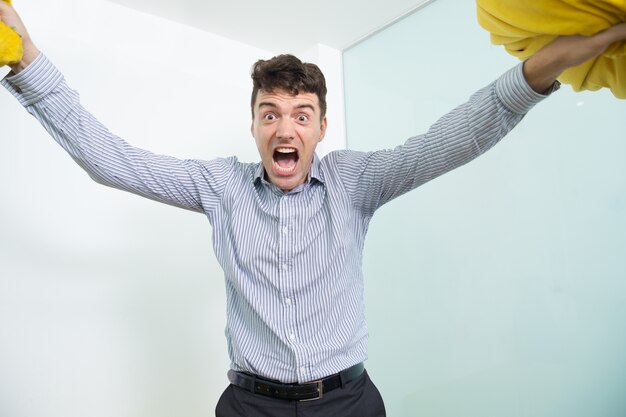 Furious Middle-aged Man Raising Two Pillows