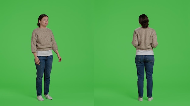 Free photo furious negative adult standing on full body greenscreen, showing disappointment and disapproval over green screen backdrop. frustrated upset model being angry and displeased in studio.