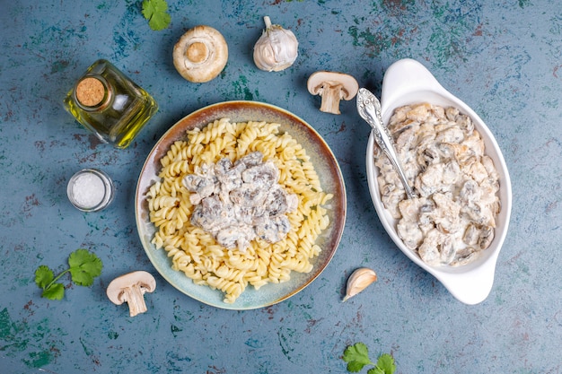 Fusilli pasta with mushrooms and chicken, top view