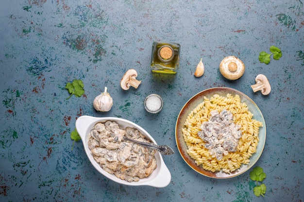 Fusilli pasta with mushrooms and chicken, top view