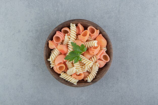 木製のボウルにフジッリと貝殻のパスタ