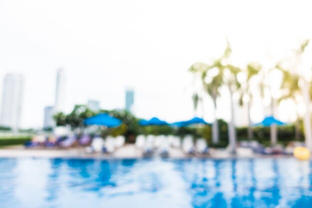 Fuzzy background with palm trees and deck chairs