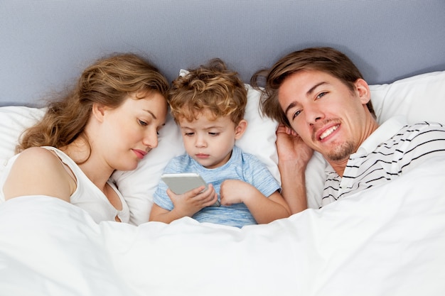 gadget son bed togetherness parenthood