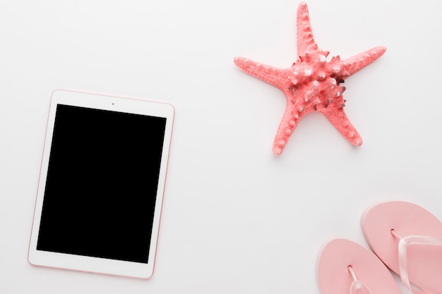 Free photo gadget with starfish on light background