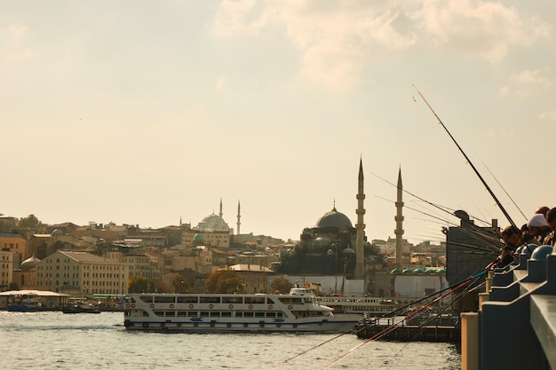 Free photo galata bridge with fishermen in istanbul with a view of the city and ship