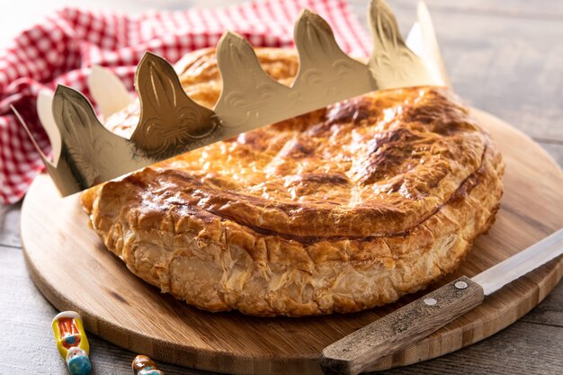 Galette des rois on wooden table. Traditional Epiphany cake in France