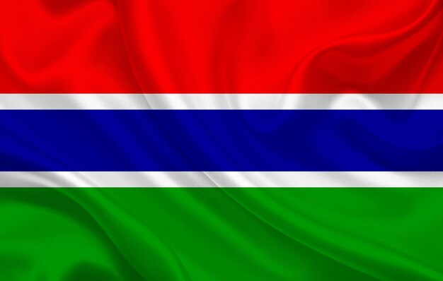 Gambia country flag on wavy silk fabric background panorama - illustration