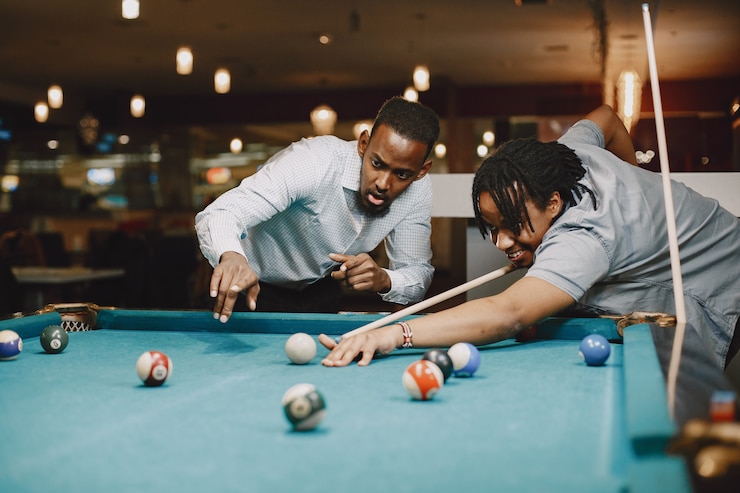 Free Photo game of billiards. men with a cane. men's games