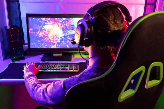 gamer playing indoors side view