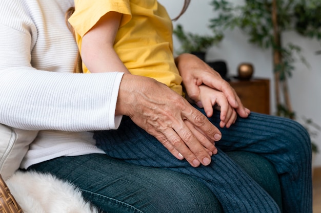 Gandparent holding grandchild close up