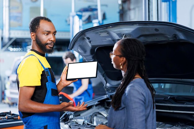 Garage serviceman holds mockup device