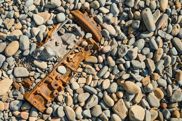 Garbage on a clean wild beach, pollution of nature with industrial waste and other garbage on the seashore. Dumping garbage into the ocean. Ecological concept, top view