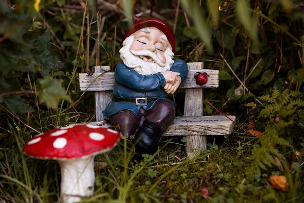 Free photo garden gnome with funny hat outdoors