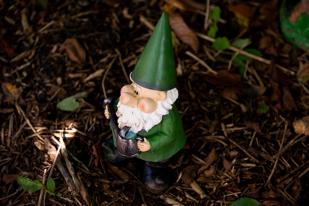 Free photo garden gnome with funny hat outdoors