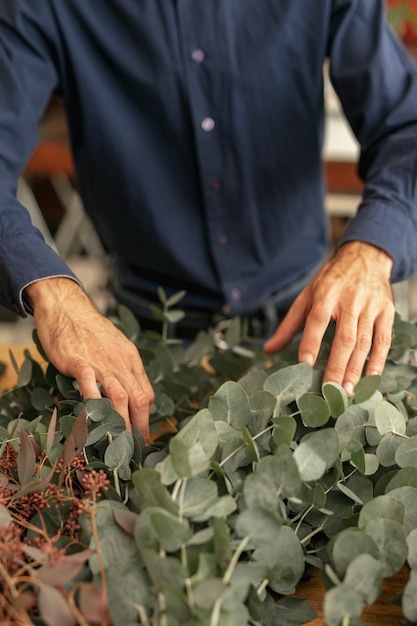 Free photo gardener arranging plants high view