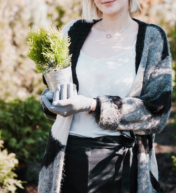 Gardener holding plant