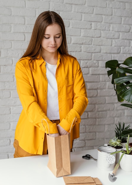 Gardener preparing a gift with a plant