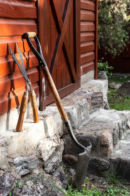 Gardener tools beside house