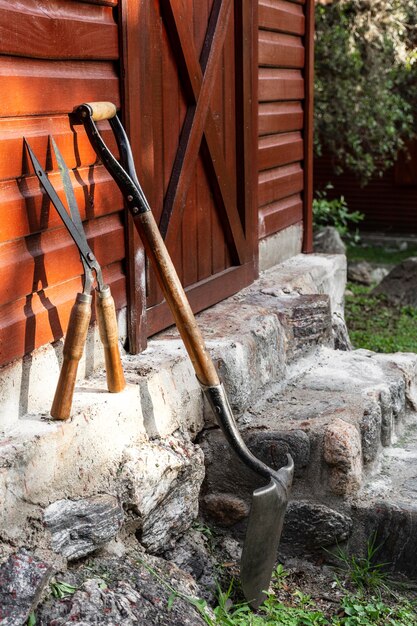 Gardener tools beside house