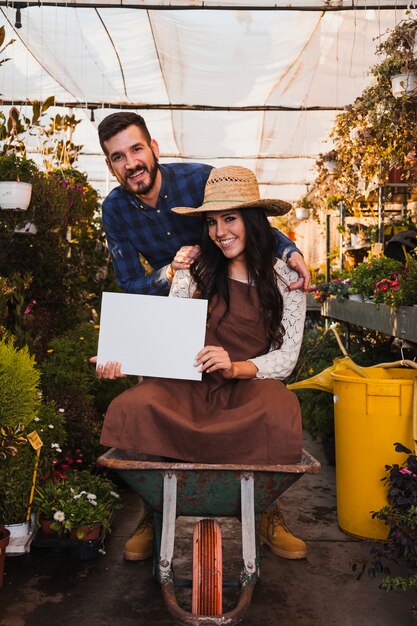 Gardeners with wheelbarrow showing paper sheet