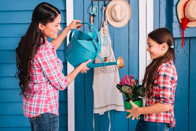 Gardening concept with mother and daughter