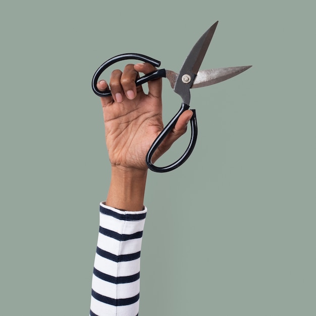 Free photo gardening tool scissor held by a woman's hand