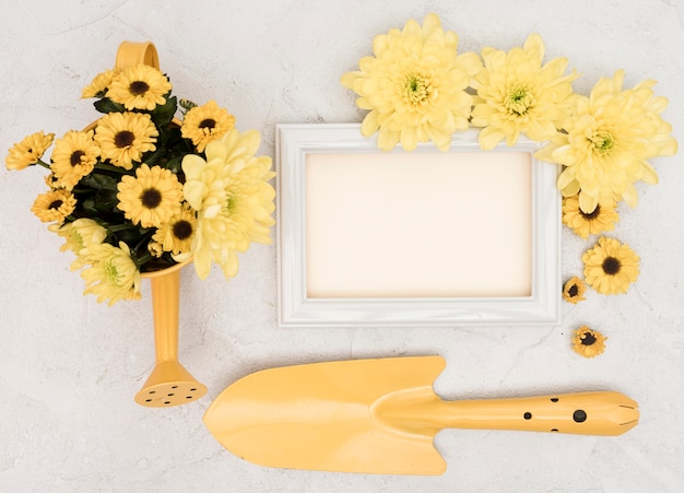 Free photo gardening yellow tools and flowers with copy space frame