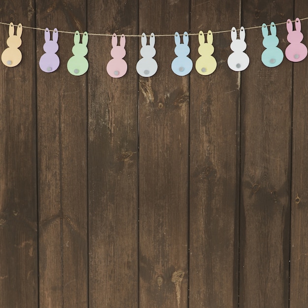 Free photo garland with paper rabbits on wood