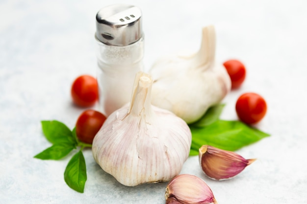 Garlic and cherry tomatoes with salt shaker