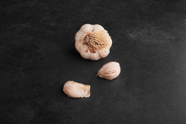 Garlic cloves isolated on black background. 