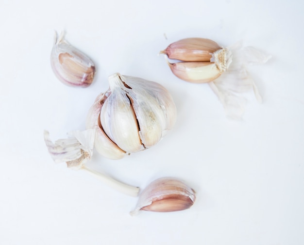 Garlic cloves on yellow background