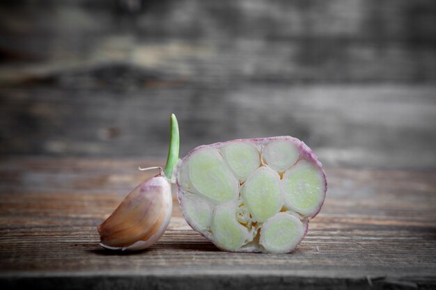 Garlic cut in a half on a wooden background. side view.