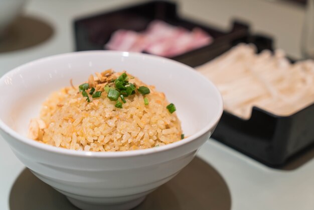 garlic fried rice with vegetables on top