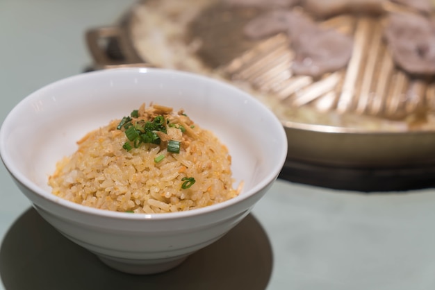 garlic fried rice with vegetables on top