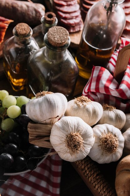 Garlic and grapes near oils