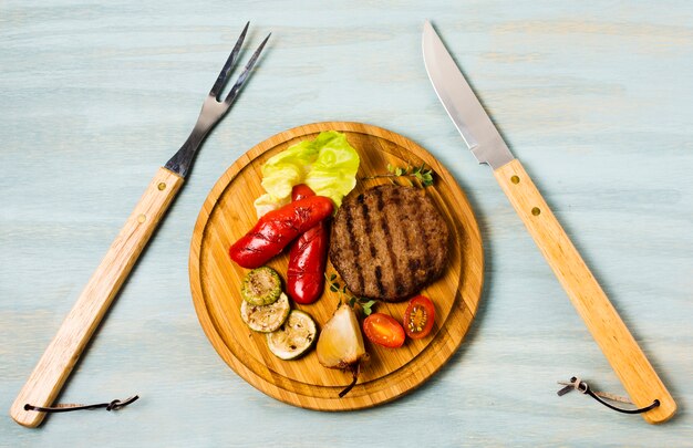 Garnished steak serving with cutlery