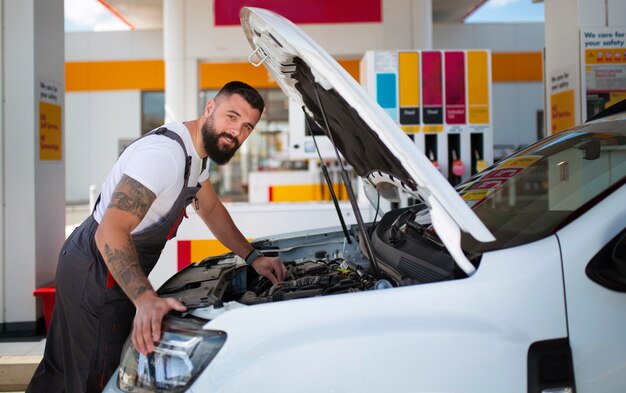 Gas station worker taking care of client's car