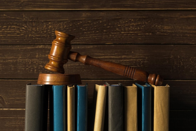 Gavel With Books On Old Wooden Desk