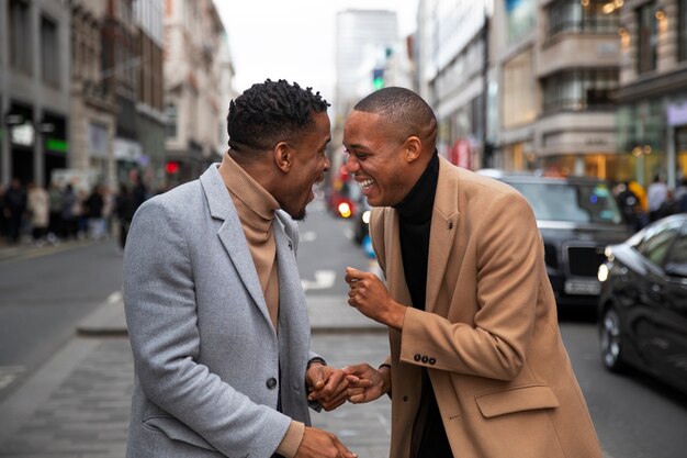 Gay couple being affectionate and acting goofy on a city street