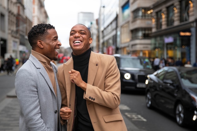 Gay couple being affectionate and acting goofy on a city street