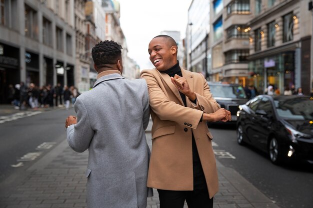 Gay couple being affectionate and acting goofy on a city street