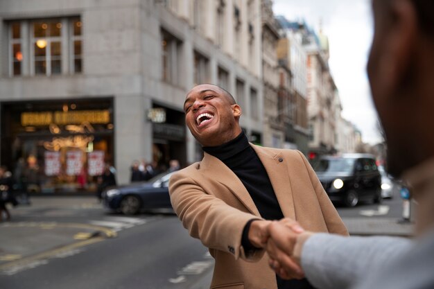 Gay couple being affectionate and acting goofy on a city street