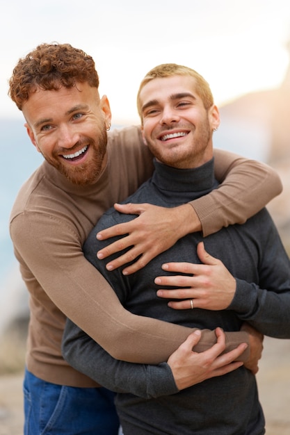 Foto gratuita una coppia gay è affettuosa e trascorre del tempo insieme sulla spiaggia