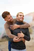 Free photo gay couple being affectionate and spending time together on the beach