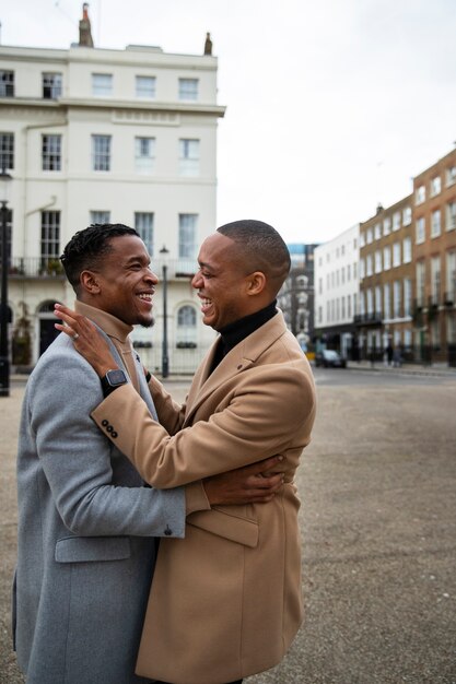 Free photo gay couple out on a date in the city showing affection