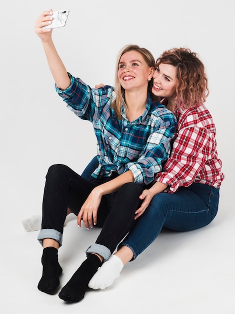 Gay couple smiling and taking selfie for valentines