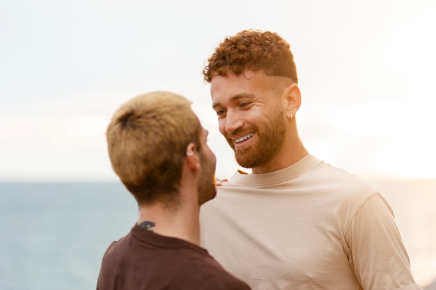 Free photo gay couple spending time together on the beach