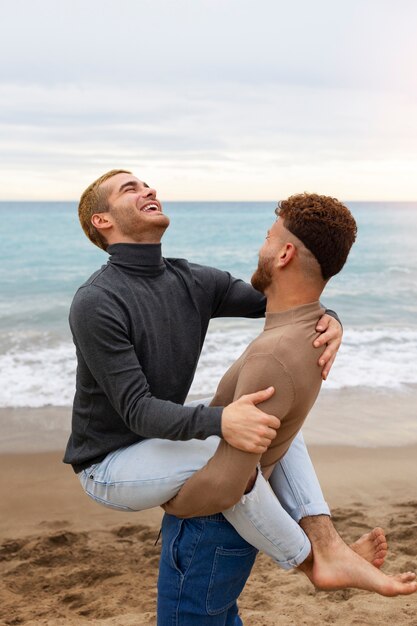 Gay couple spending time together on the beach