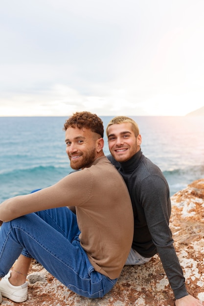 Free photo gay couple spending time together on the beach